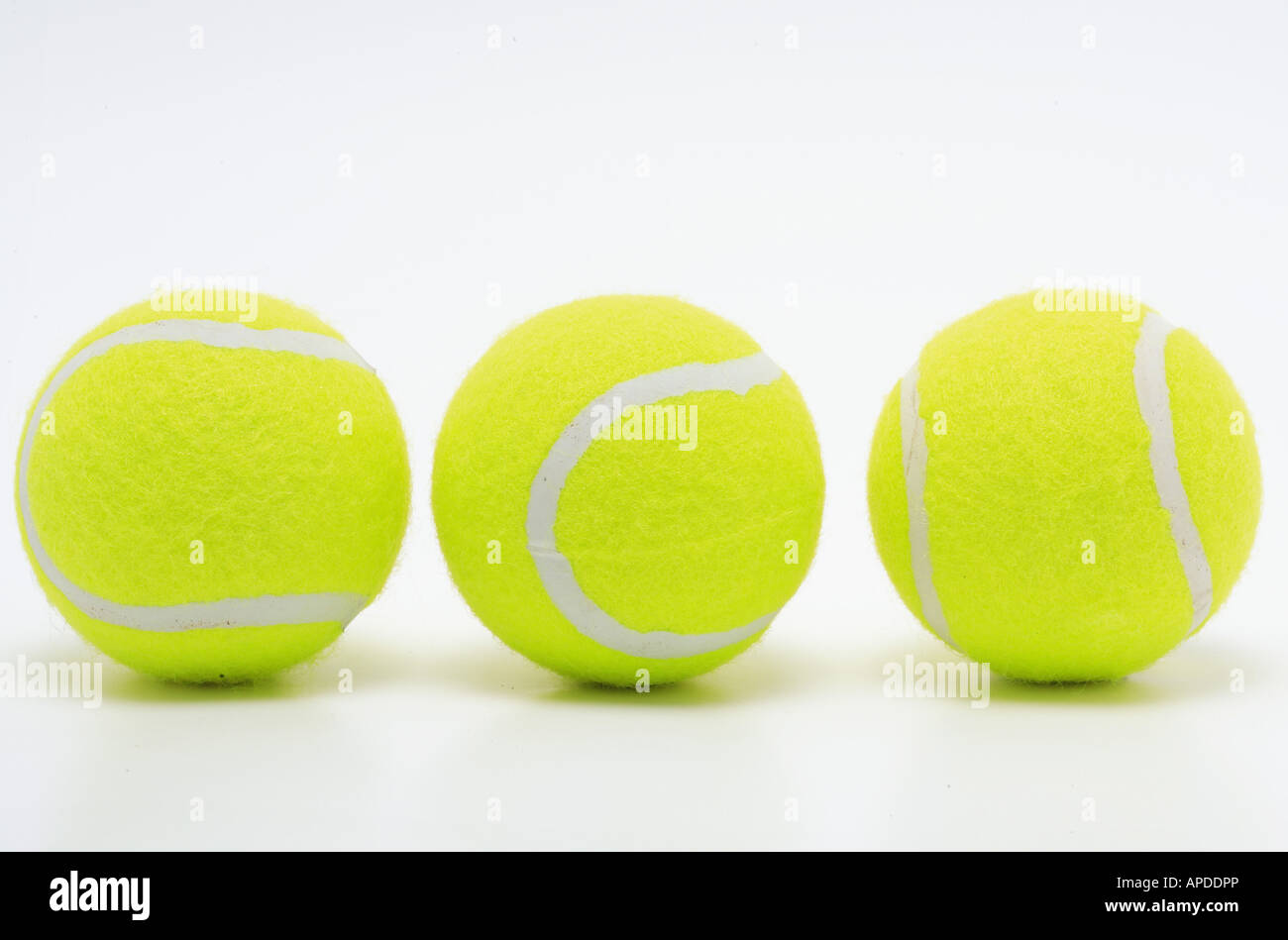 three yellow tennis balls on white surface Stock Photo Alamy