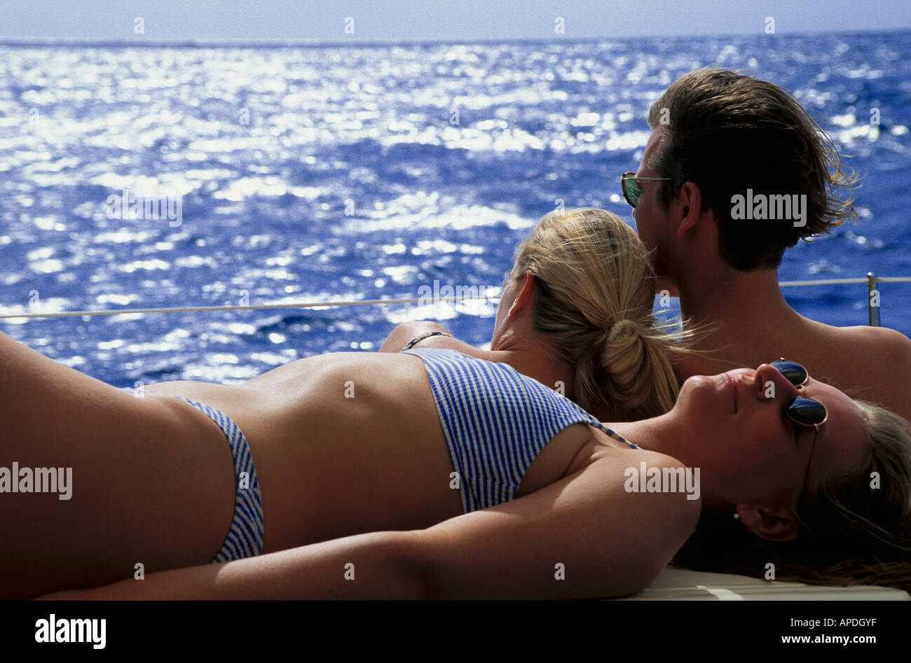 Sunbathing on boat, Caribbean Sea Stock Photo