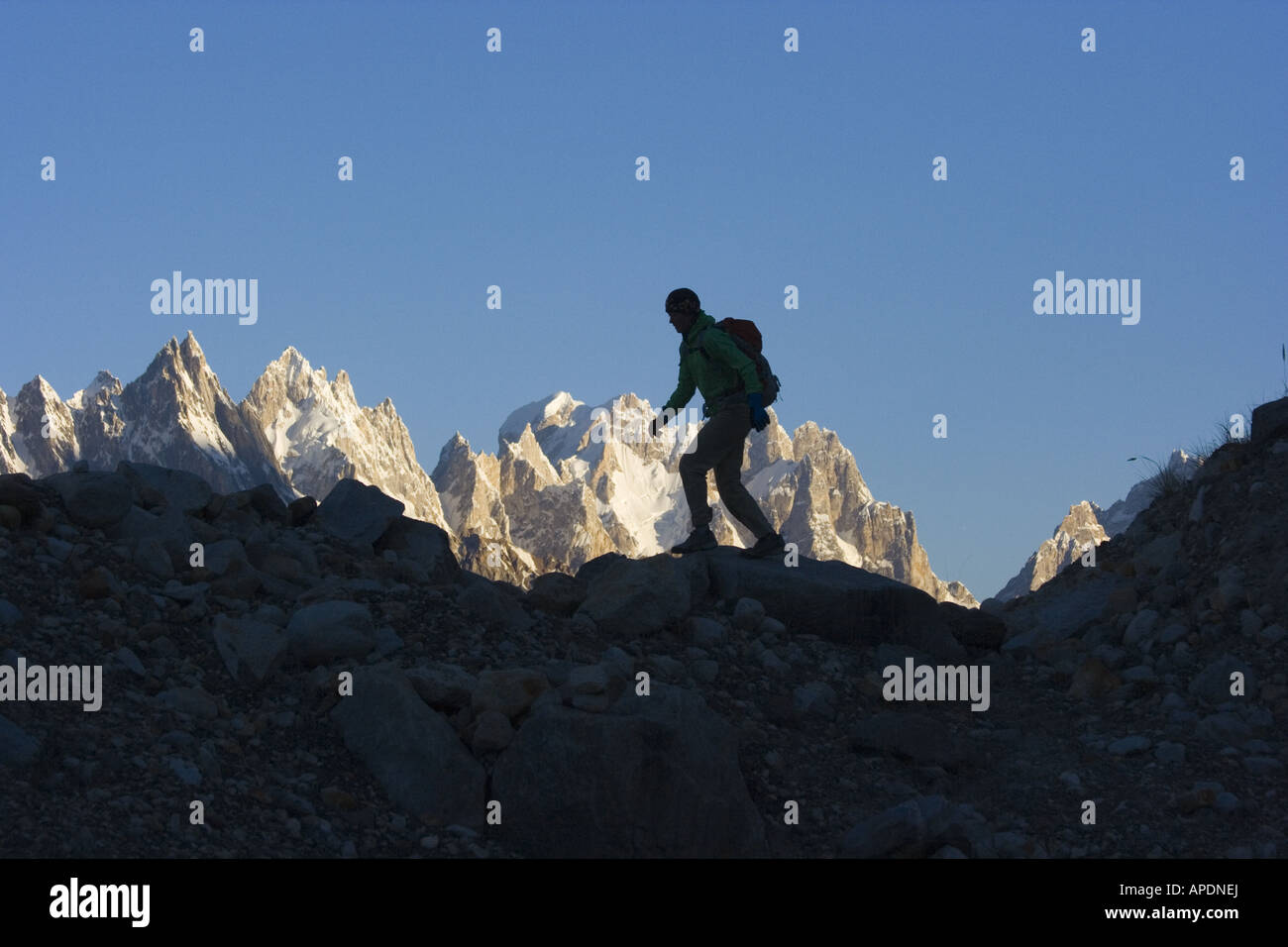 A silhouette of a woman hiker on the Biafo glacier in the Karakoram Himalaya in Pakistan Stock Photo