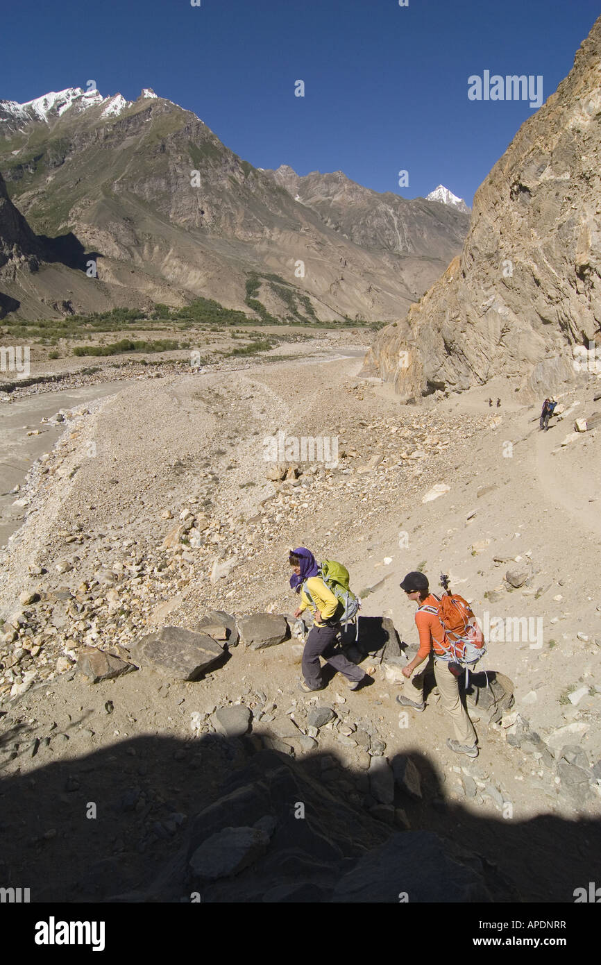 Two women hiking towards the Biafo glacier near Askole in the Karakoram Himalya of Pakistan Stock Photo
