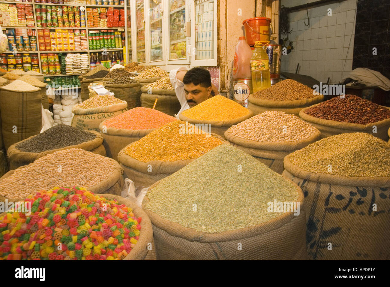 A shopkeeper selling grain in the old bazaar in Rawalpindi in Pakistan Stock Photo