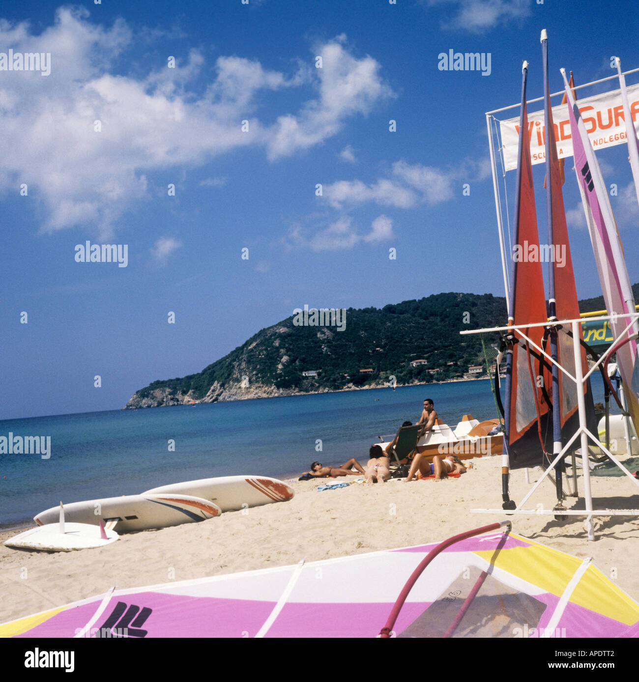 Windsurfing is a popular pastime on the fine sand of Biodola Bay on Elba, an  Italian island in the Mediterranean. Stock Photo