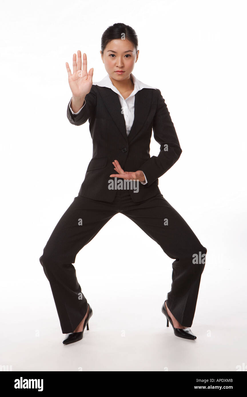 Young woman in business suit in kung fu pose Stock Photo Alamy