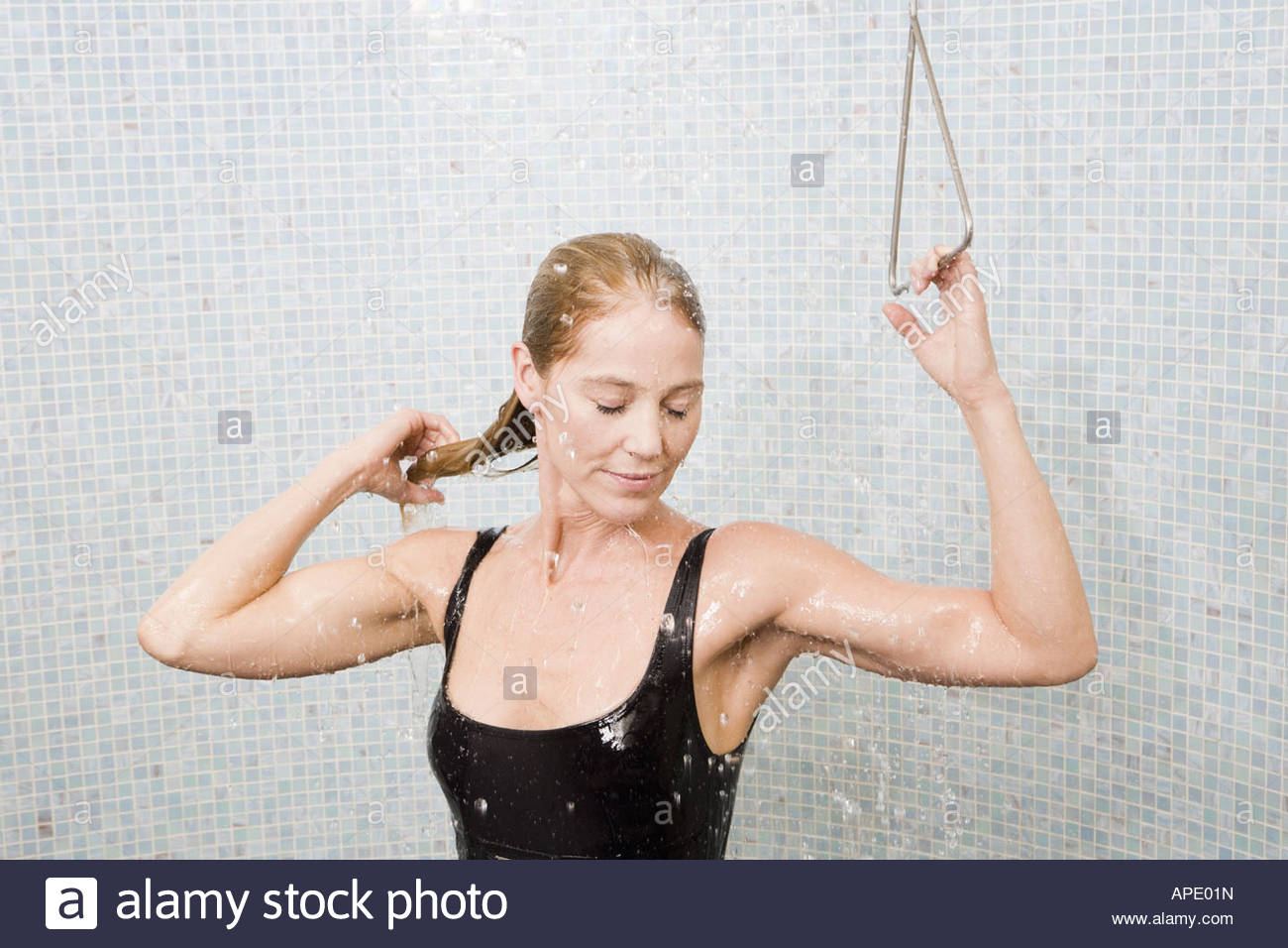 Woman in bathing suit taking shower Stock Photo 15761552 Alamy