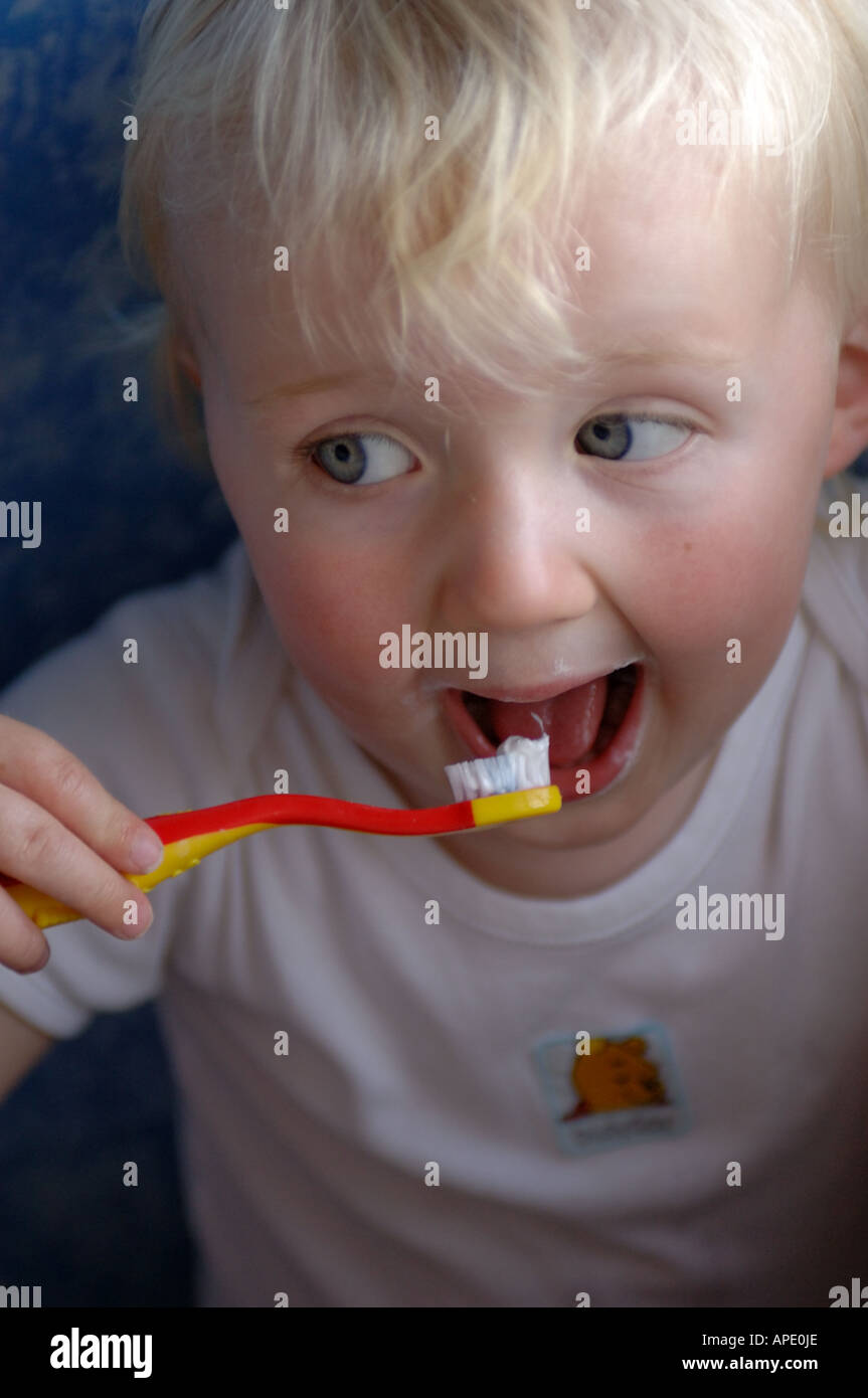 A girl with her mouth wide open as she brushed her teeth Stock Photo