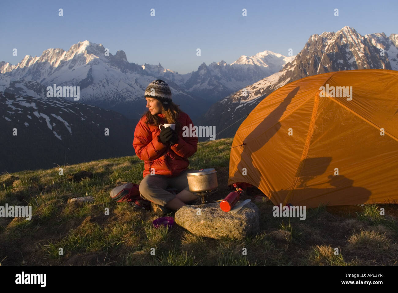 A woman cooking while camping in the French alps near Chamonix France