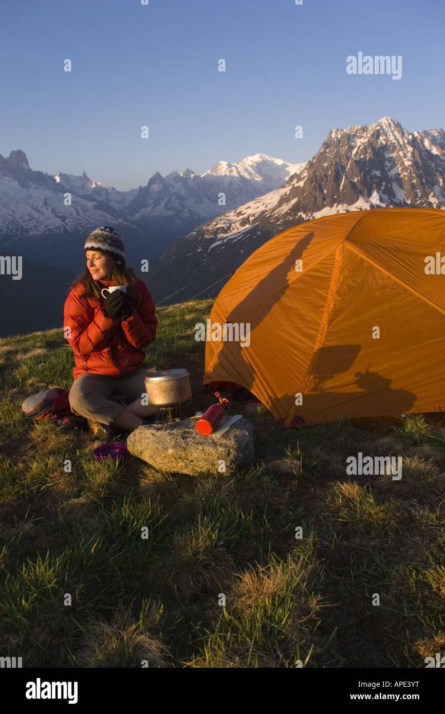 A woman cooking while camping in the French alps near Chamonix France
