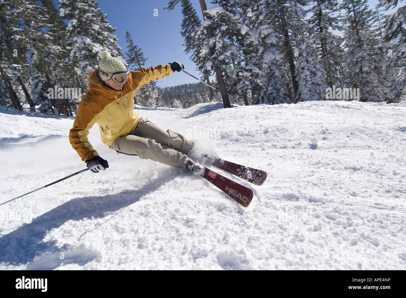A woman skiing on a groomed run at Northstar ski area near Lake Tahoe in California Stock Photo