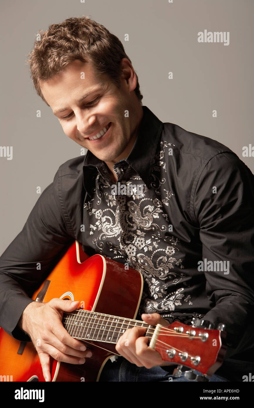 Man Playing Guitar, smiling, close-up Stock Photo