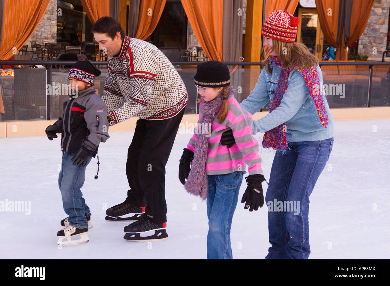 A family ice skating at Northstar ski resort near Lake Tahoe in California Stock Photo