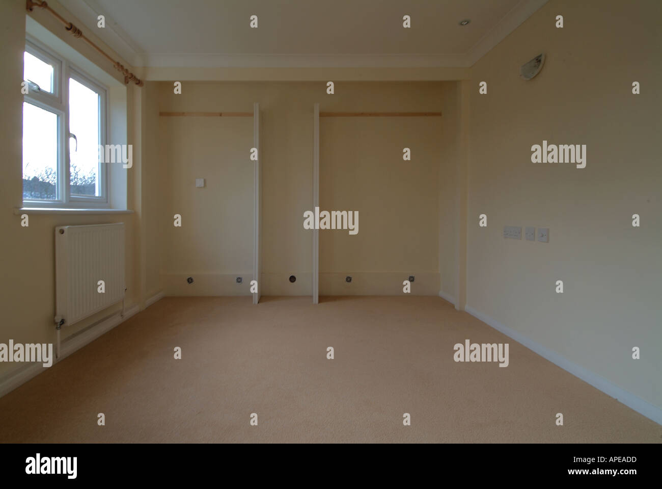 Fitted carpet in new bedroom awaiting fitting of sliding wardrobe track