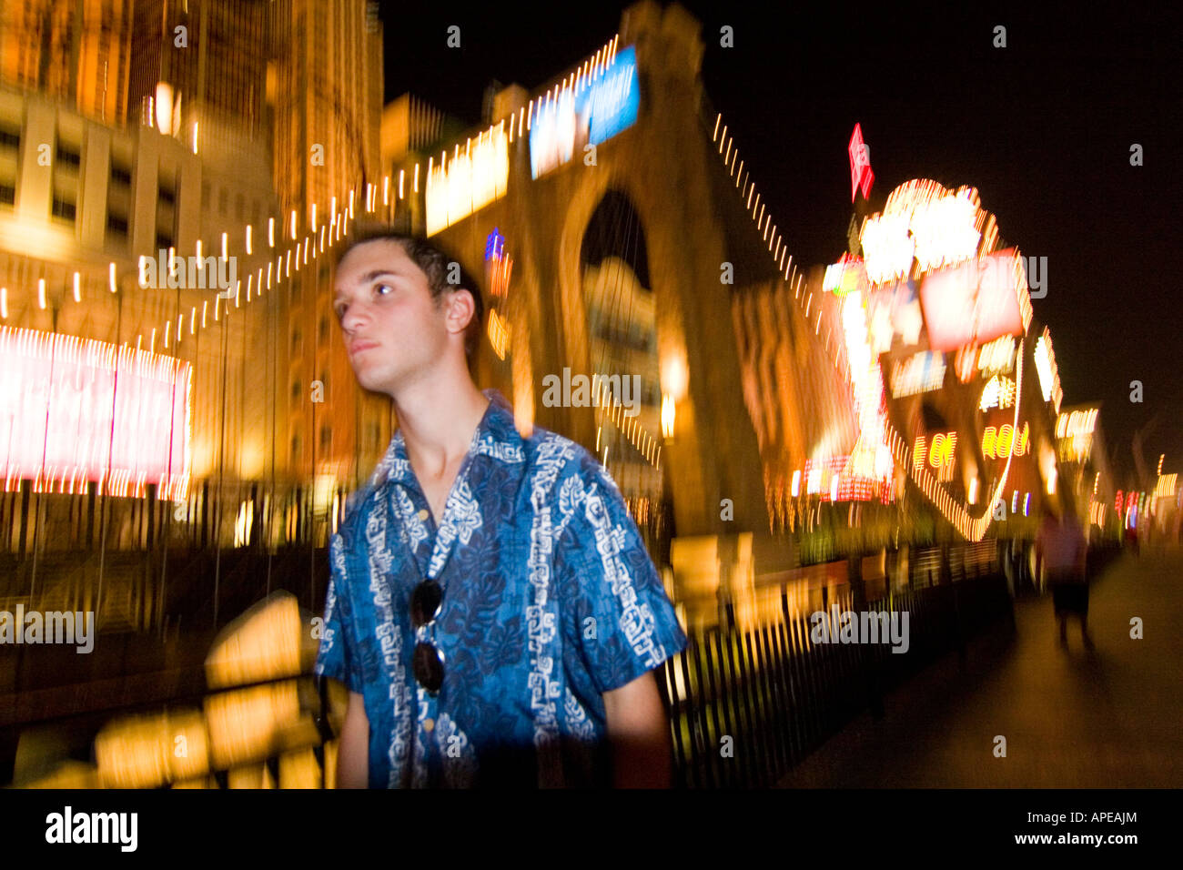 A young man enjoys a nighttime walk on the Las Vegas Strip Stock Photo