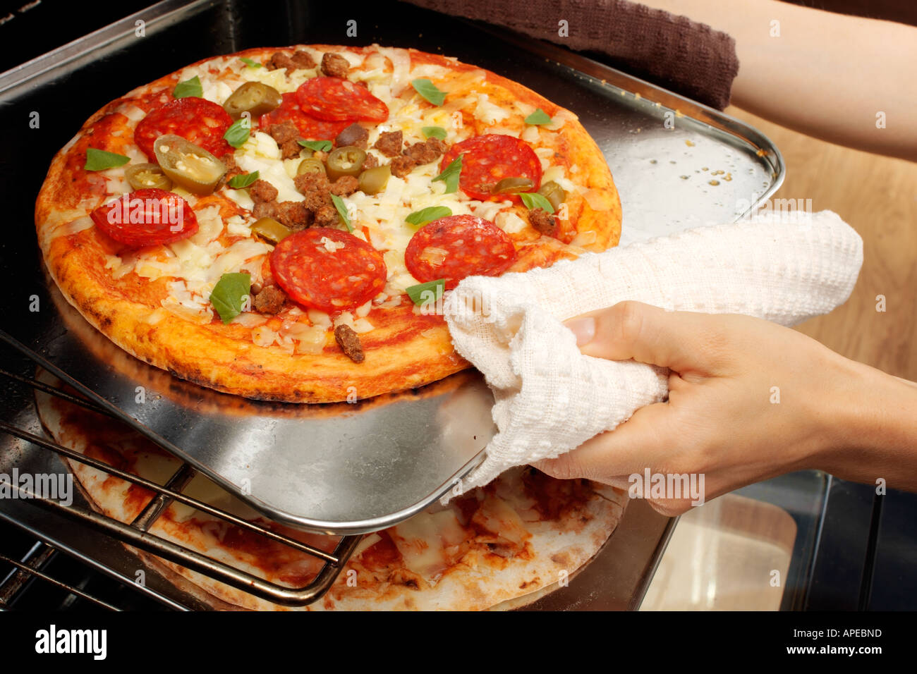 REMOVING PIZZA FROM OVEN Stock Photo Alamy