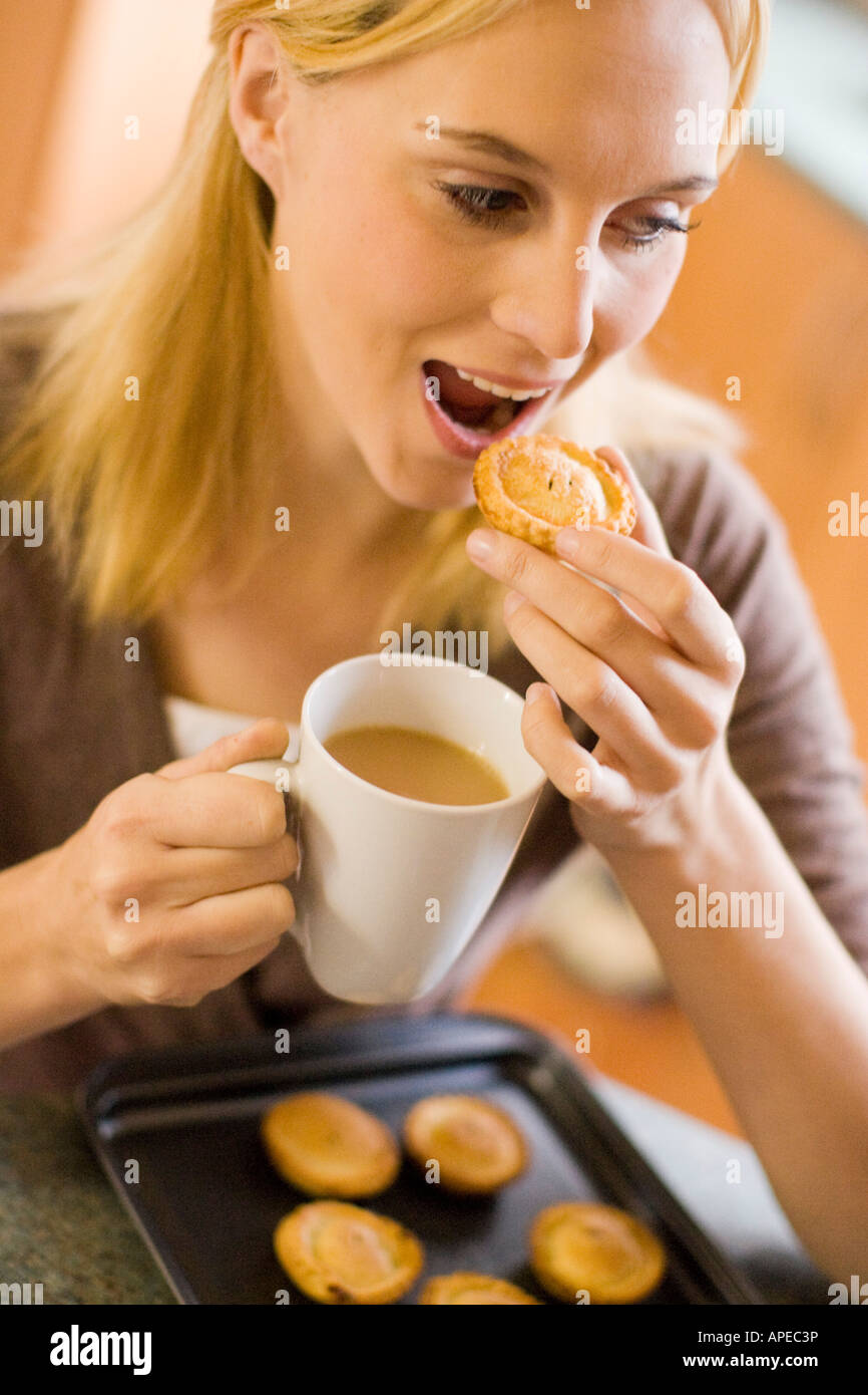 Woman eating mince pies Stock Photo