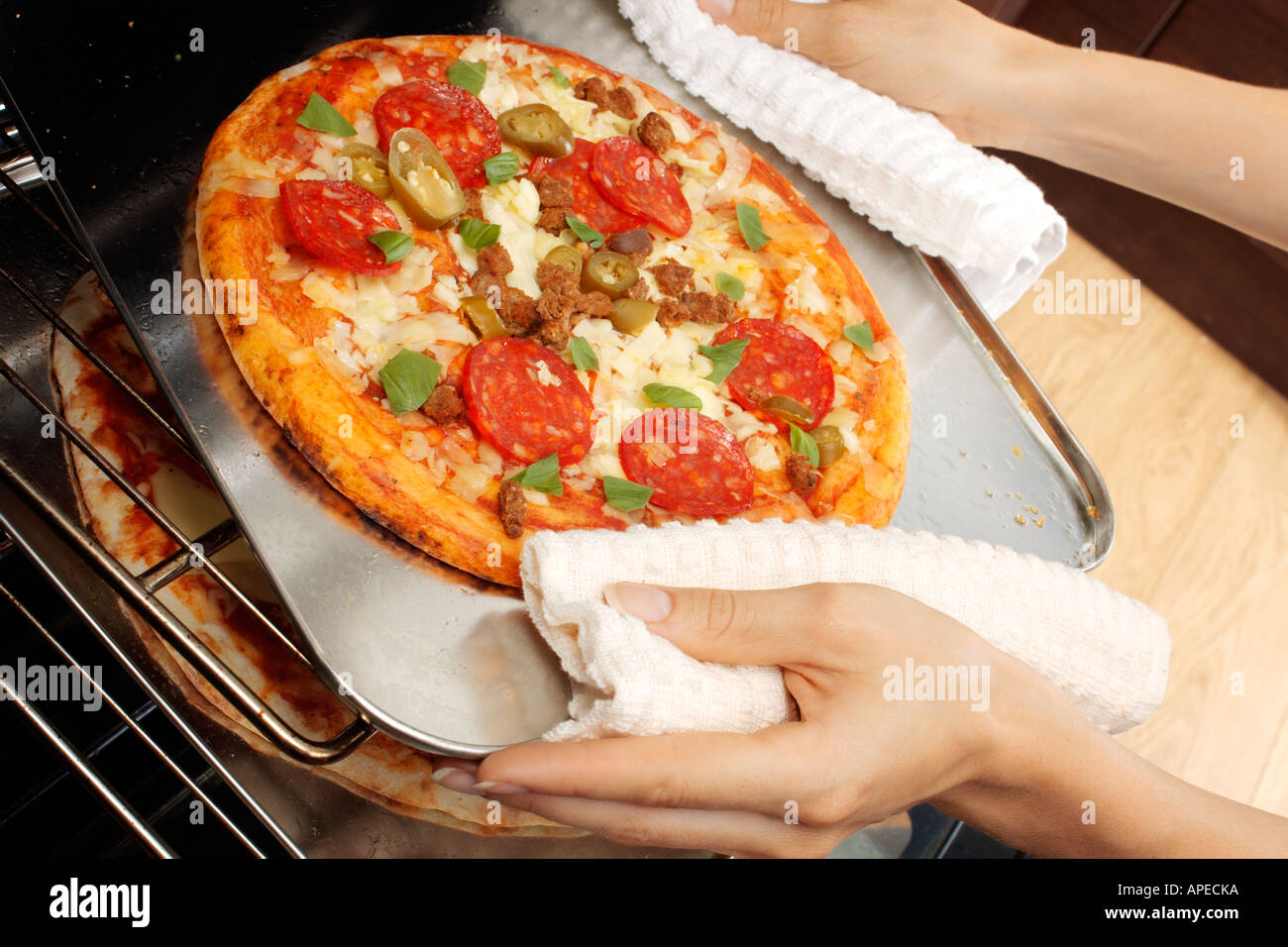 REMOVING PIZZA FROM OVEN Stock Photo Alamy