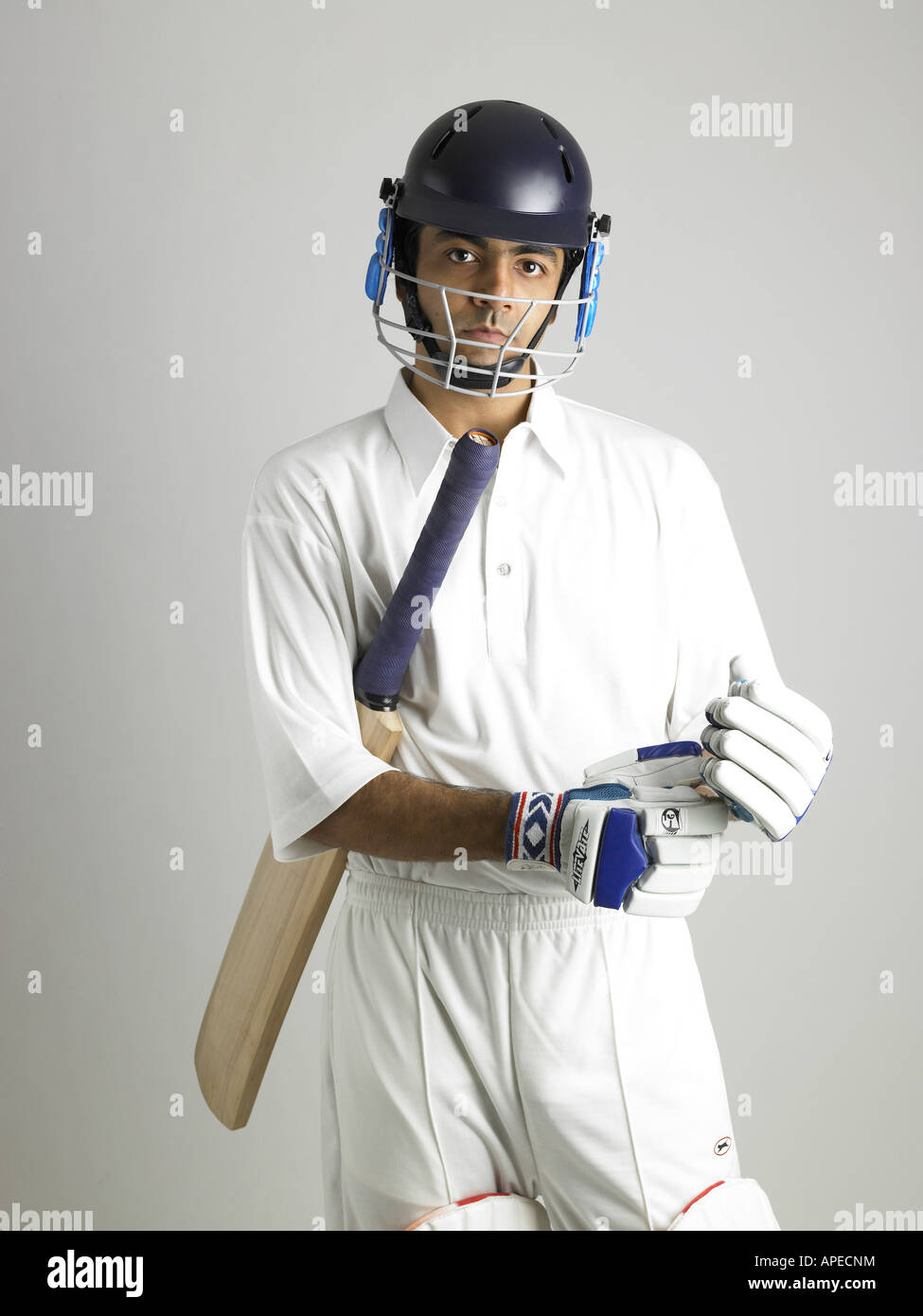 Indian batsman wearing hand gloves getting ready for cricket match