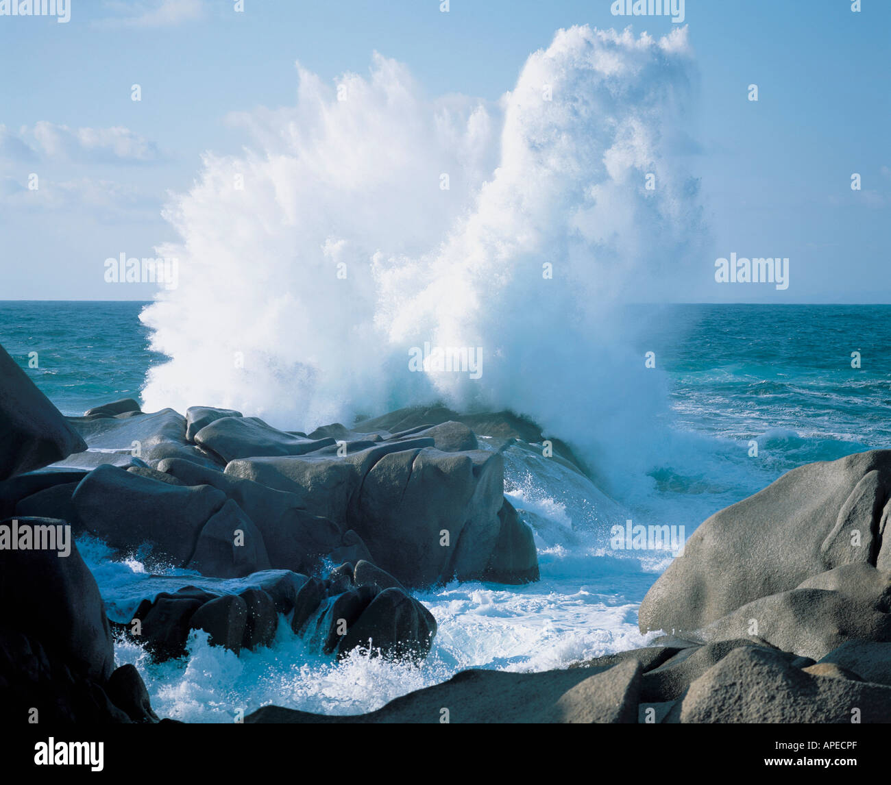 Waves crashing on rocks at coast Stock Photo
