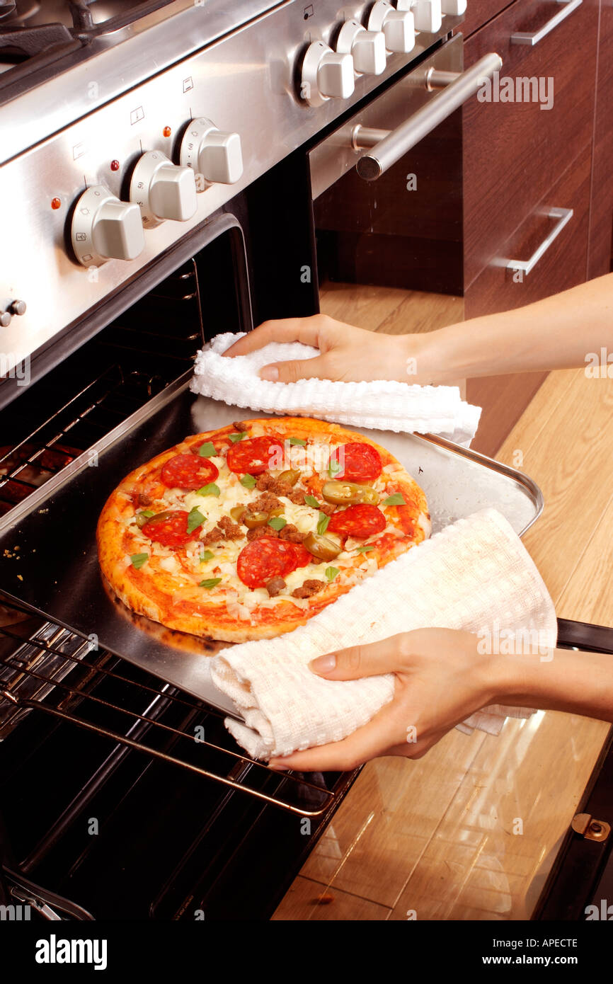 REMOVING PIZZA FROM OVEN Stock Photo Alamy