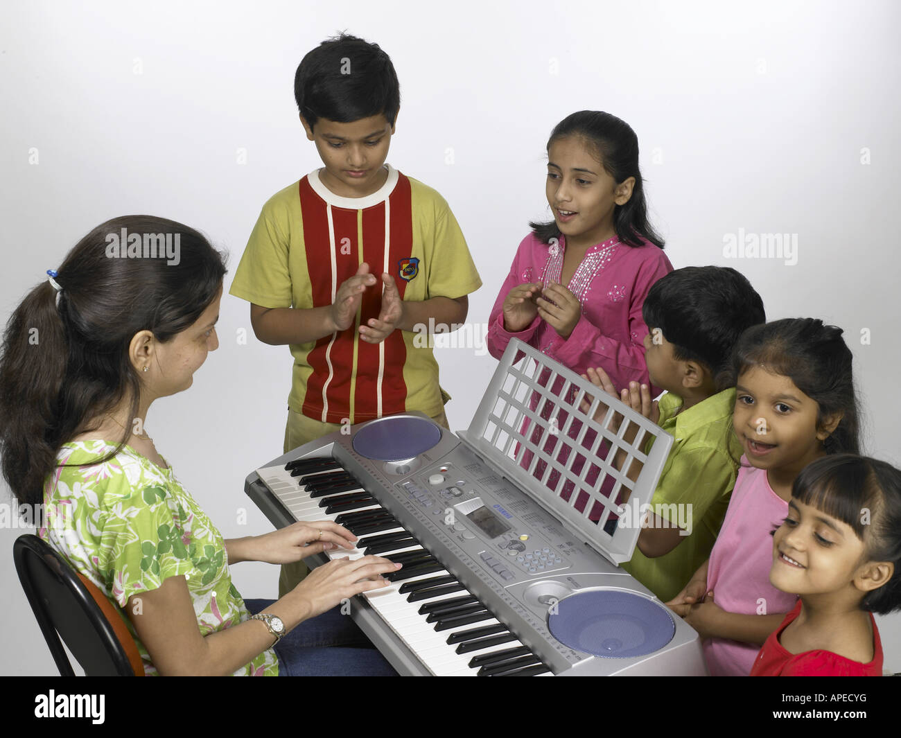 Nursery teacher playing piano children hi-res stock photography and images  - Alamy