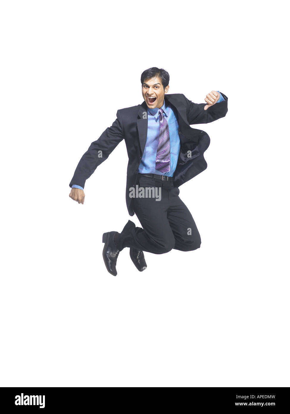 South Asian Indian executive man jumping with joy MR Stock Photo