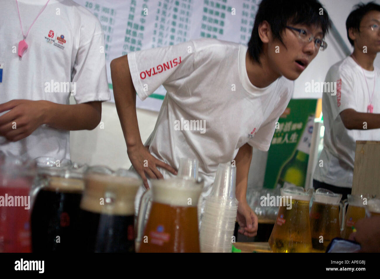 Bar staff serve beer at the Tsingtao beer festival Qingdao Shandong China Stock Photo