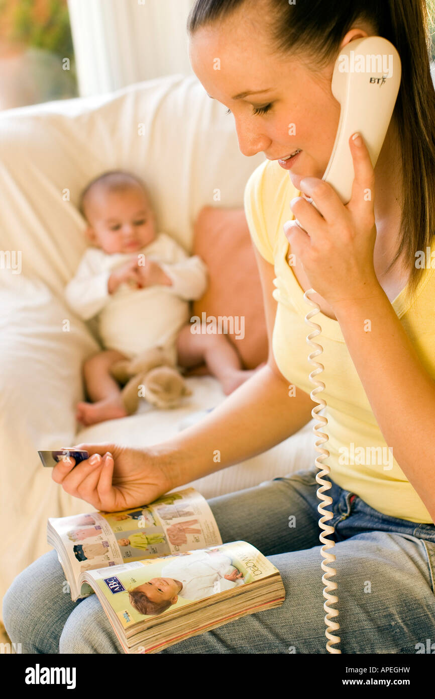 Woman ordering items from catalogue Stock Photo