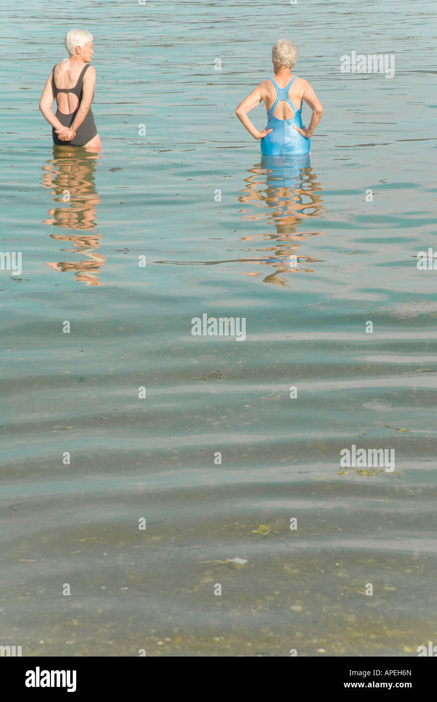 Senior women standing in water Stock Photo