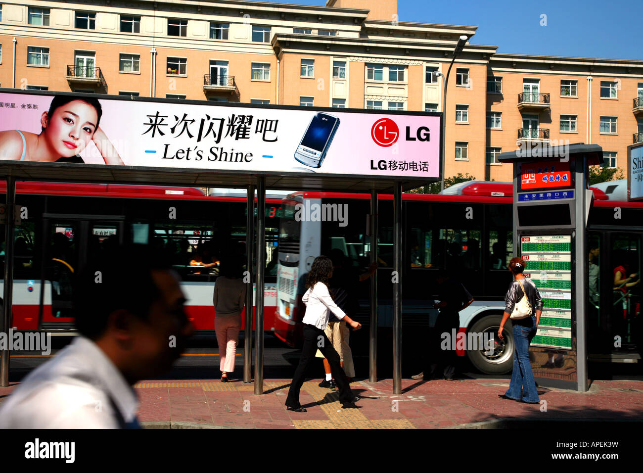 Describe the scene and the activity at a bus station. image