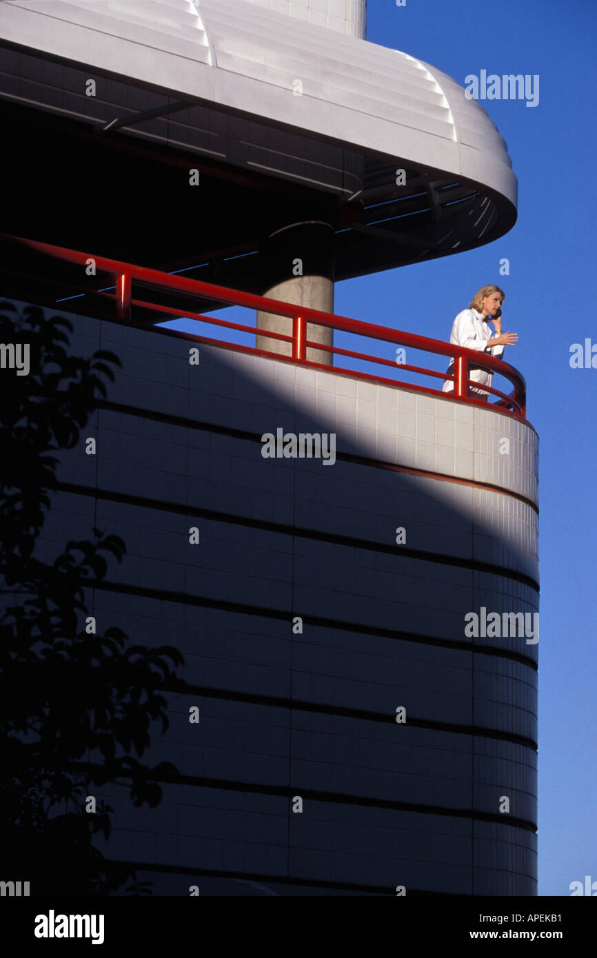 Executive talking with cell phone on balcony Stock Photo