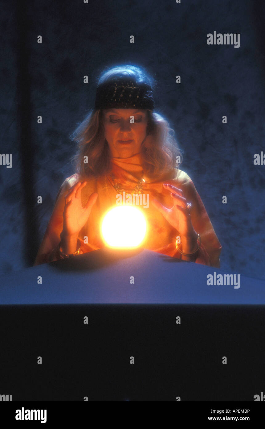 Fortune teller gazes into magic crystal ball. Stock Photo