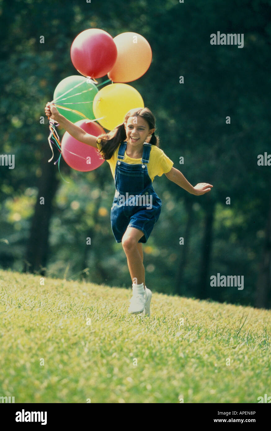 Girl running with balloons Stock Photo Alamy