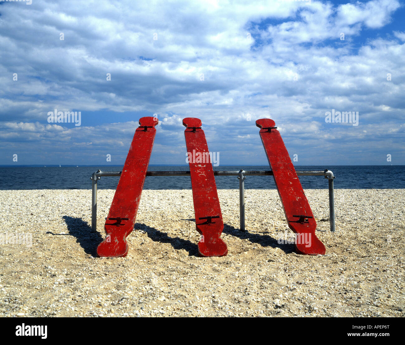 Three red see-saws on a beach in New York Stock Photo - Alamy