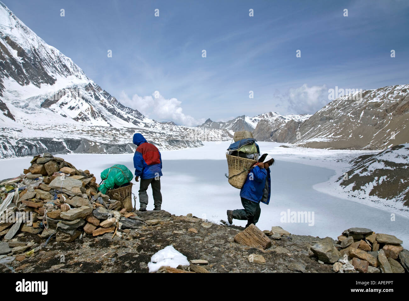 Trekkers and porter at Tilicho Lake. Highest Lake in the World ...