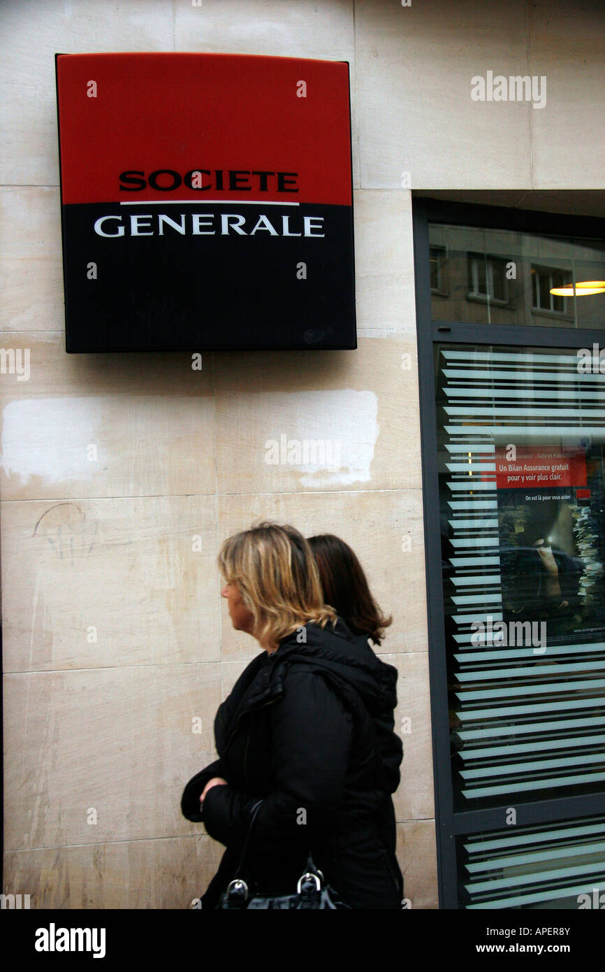 Two women walk past a Societe Generale bank in Rouen Seine Maritime France Stock Photo
