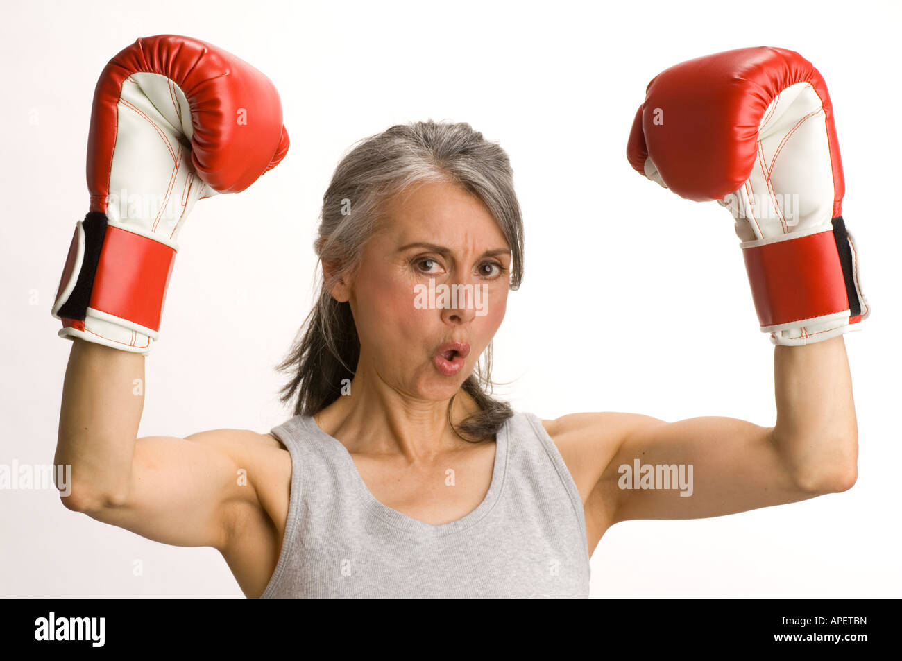 Studio shot of mature woman in boxing gloves Stock Photo - Alamy