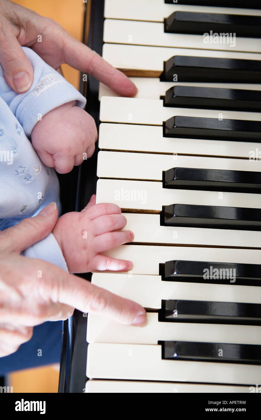 Close up of hands on a piano keyboard. Stock Photo
