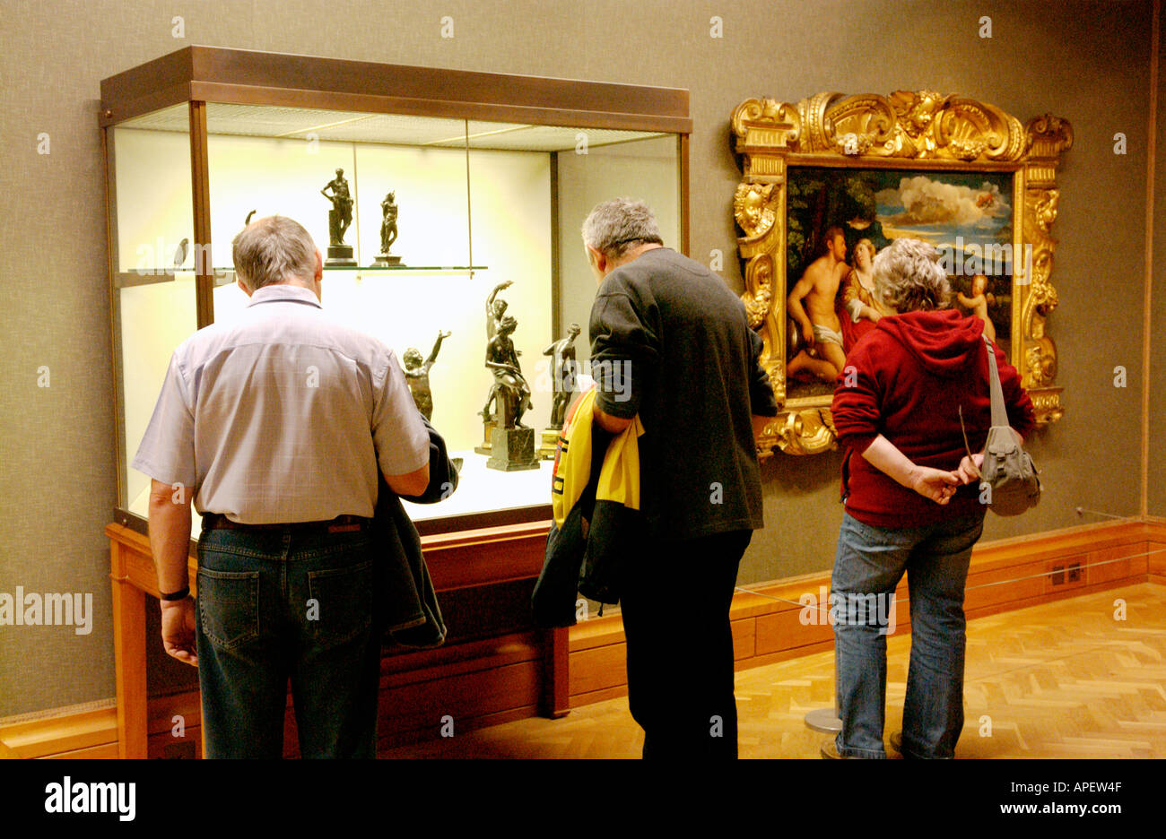 Visitors looking at an art exhibition in a gallery at the National Museum Cardiff South Wales UK