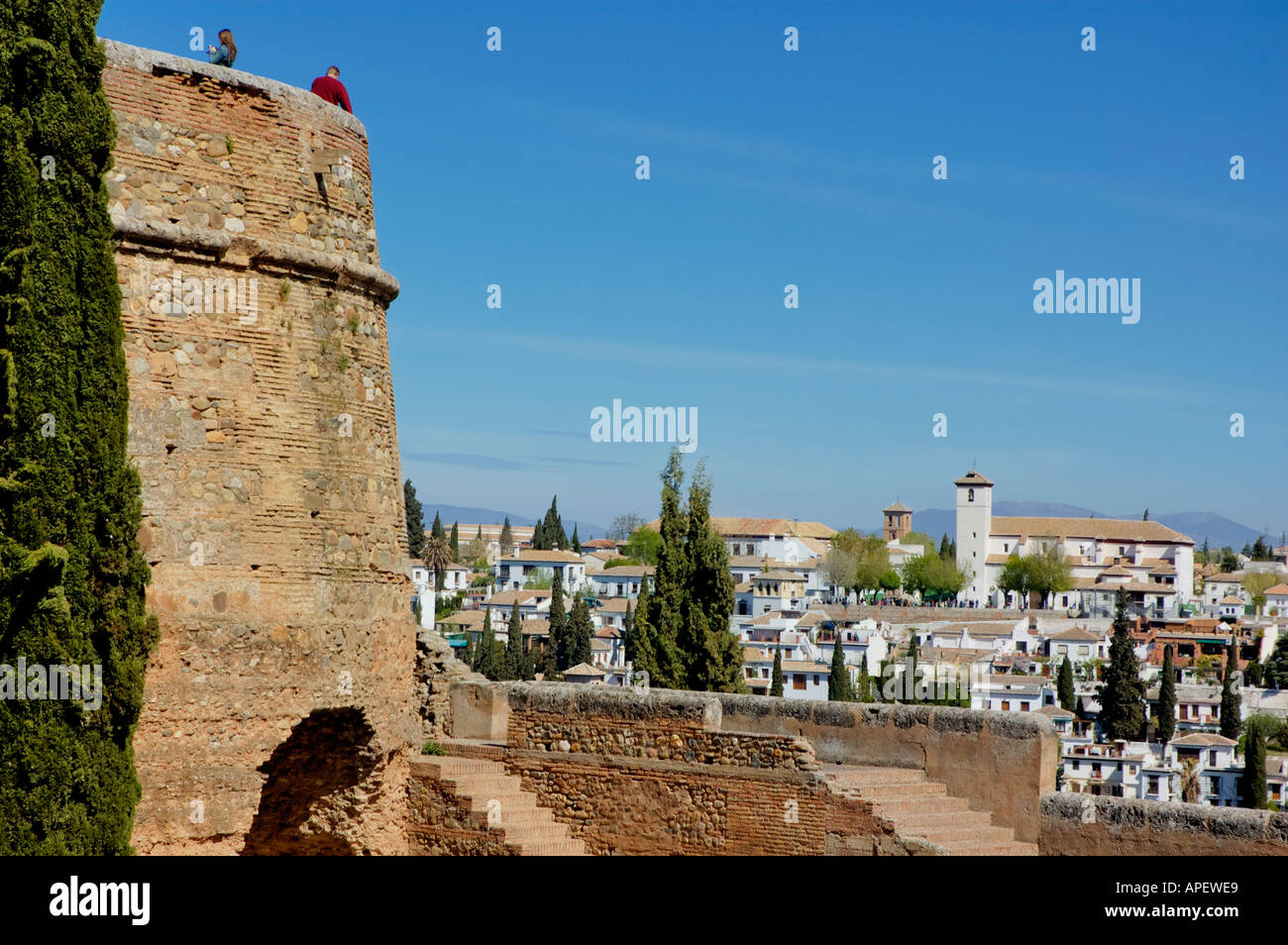 People on the Alcazaba Towers at the Alhambra Palace with the El Albayzin (Old Islamic Quarter) behind, Granada, Spain Stock Photo