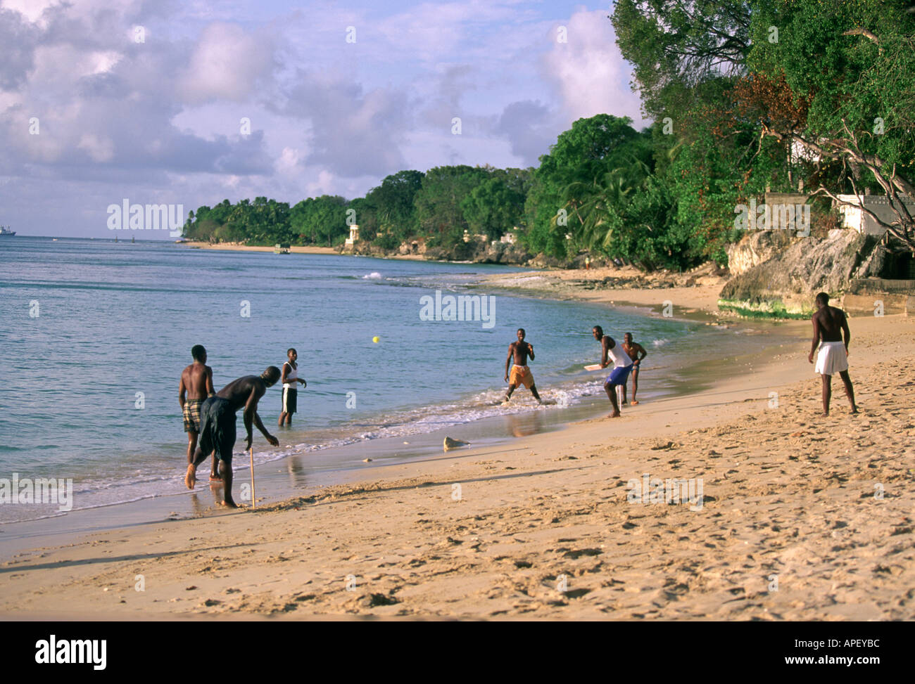 Men and boys playing beach cricket in  Barbados Stock Photo