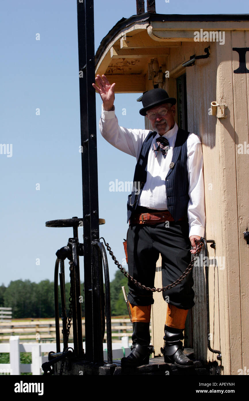 A sheriff appointed towns person riding the caboose of an old train at a reenactment Stock Photo