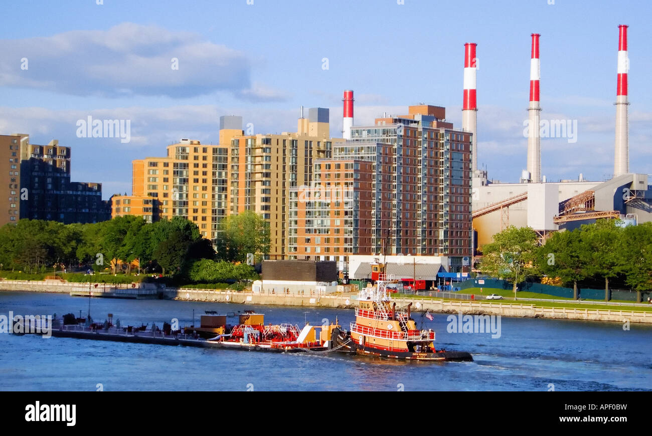 Colorful tugboat on East River, New York, electric power plant and