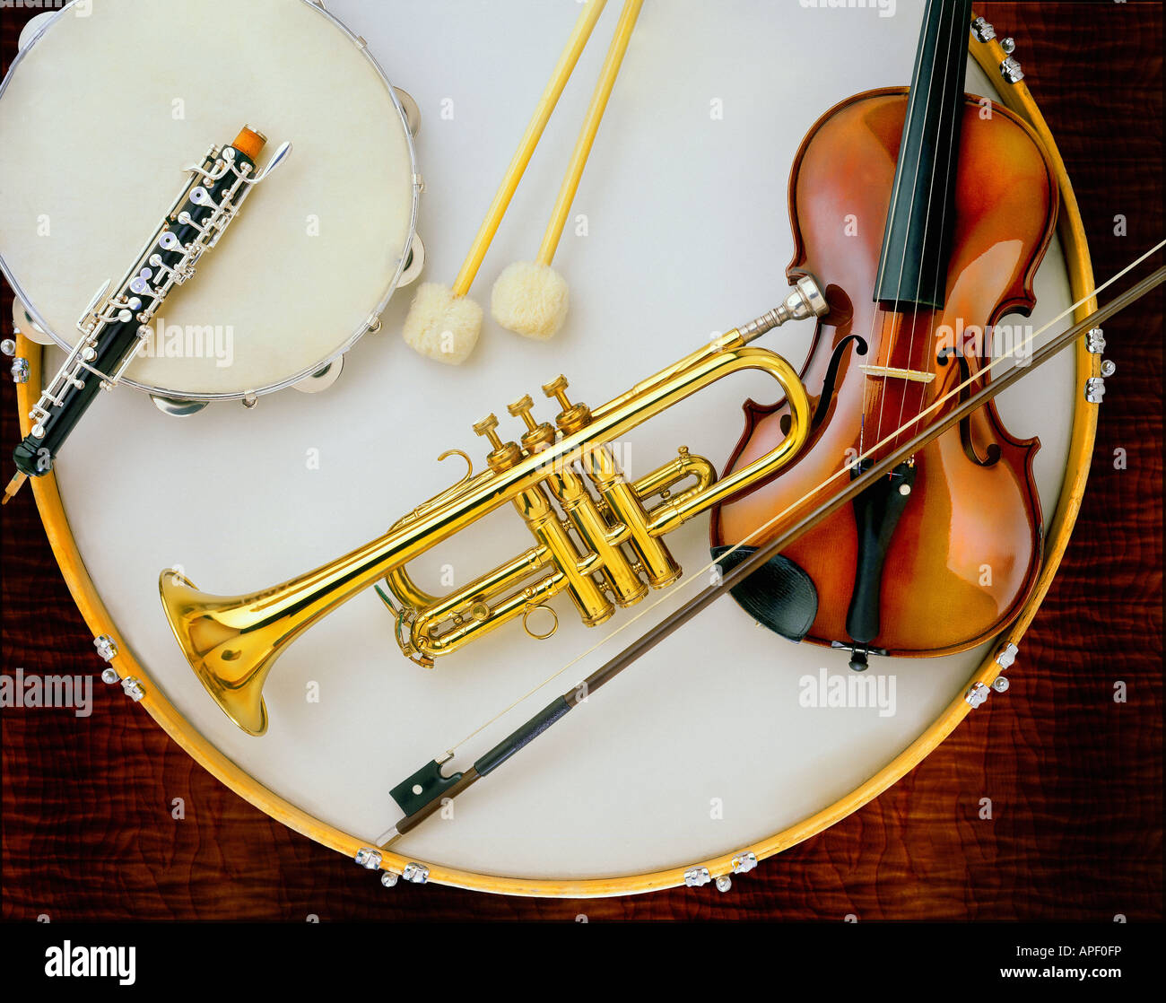 Classical musical instruments on large drum surface. Trumpet, violin, oboe,  tambourine, drumsticks Stock Photo - Alamy