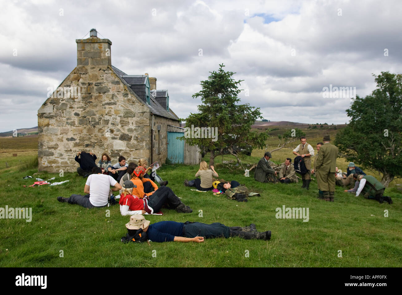 Beaters Dog Handlers and Game Keepers Taking a Midday Lunch Break at Old Croft House during Driven Red Grouse Shoot Stock Photo