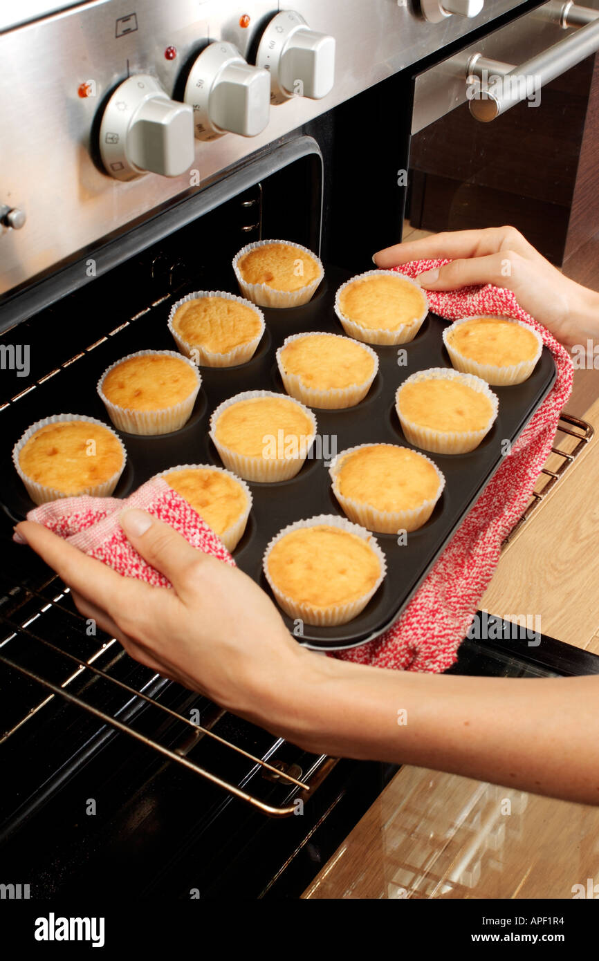 WOMAN IN KITCHEN BAKING CAKES Stock Photo