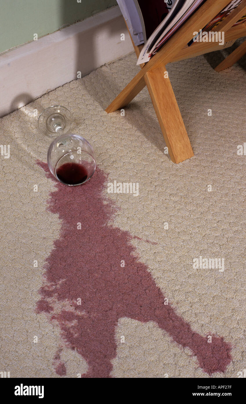 red wine spilt on white lounge carpet Stock Photo