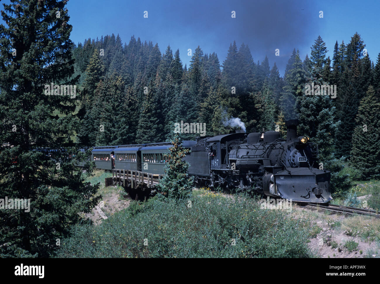 A steam engine chugs through a mountain pass in the Rockies Stock Photo ...