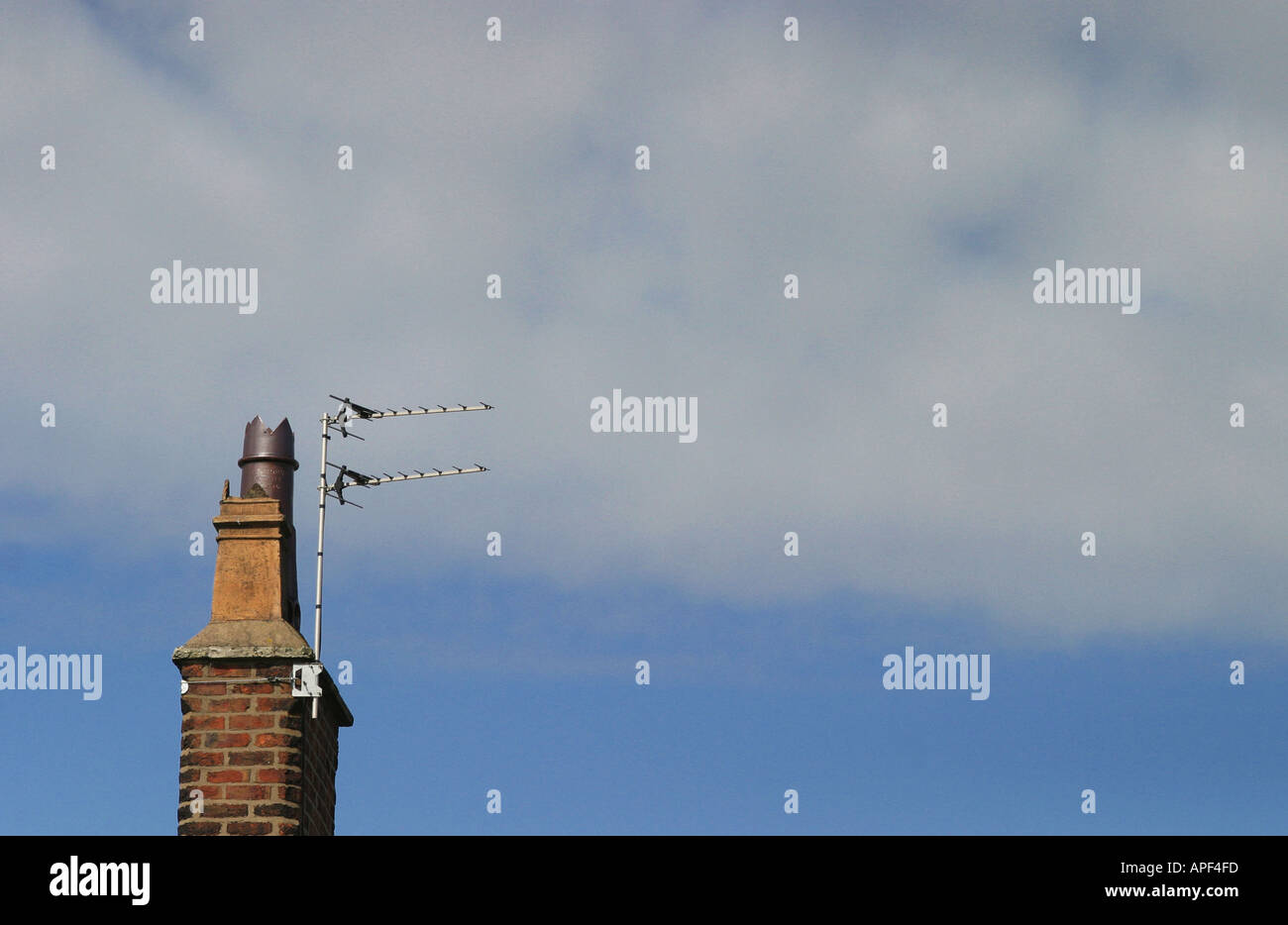 Single red brick chimney against blue sky with clouds Stock Photo - Alamy