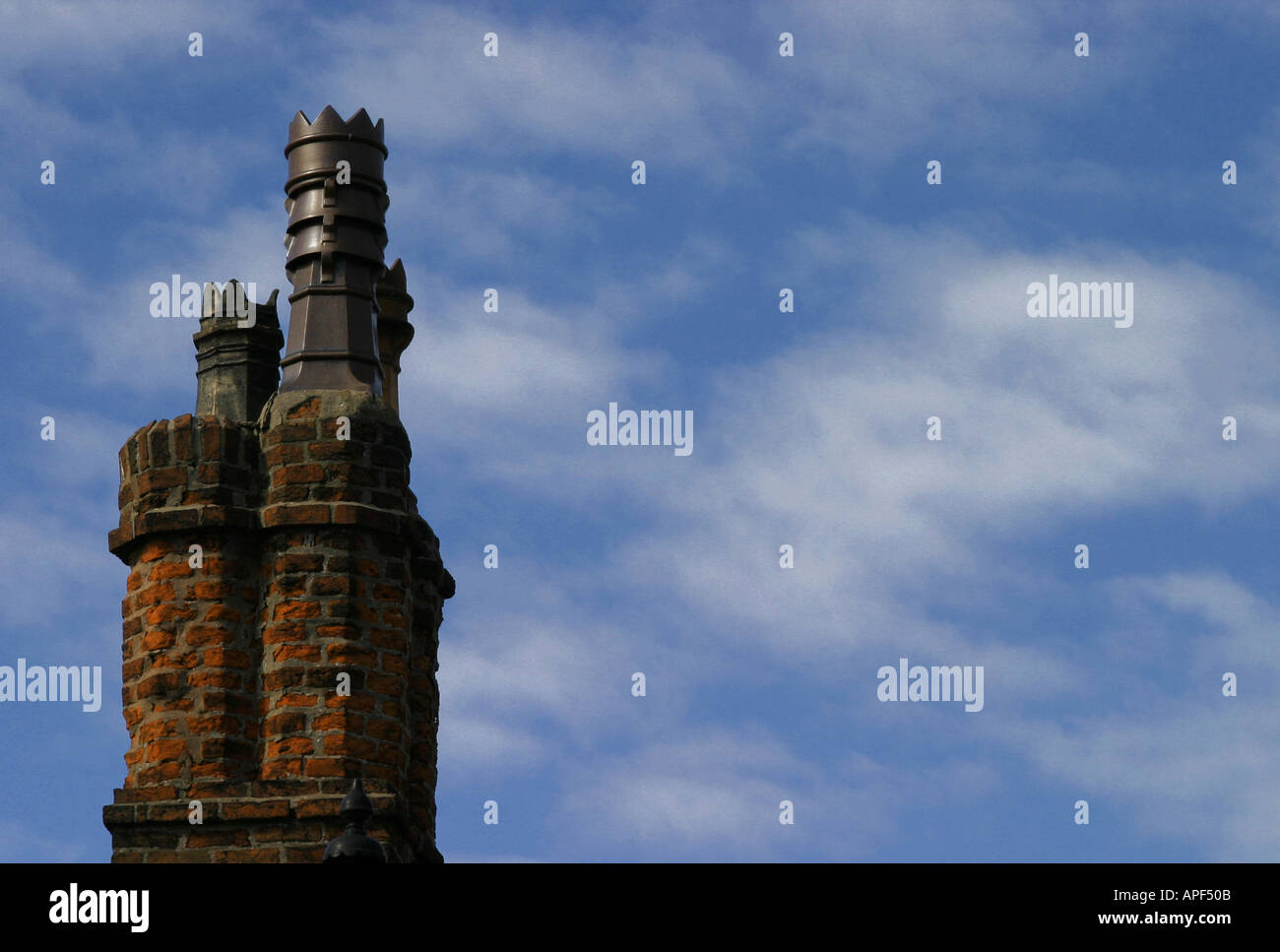 Single red brick chimney against blue sky with clouds Stock Photo - Alamy