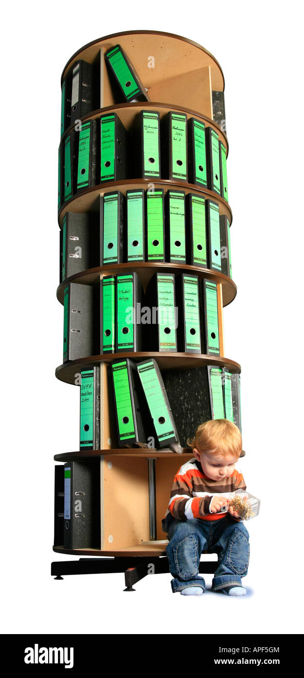 small boy sitting in front of a foler storage rack Stock Photo - Alamy