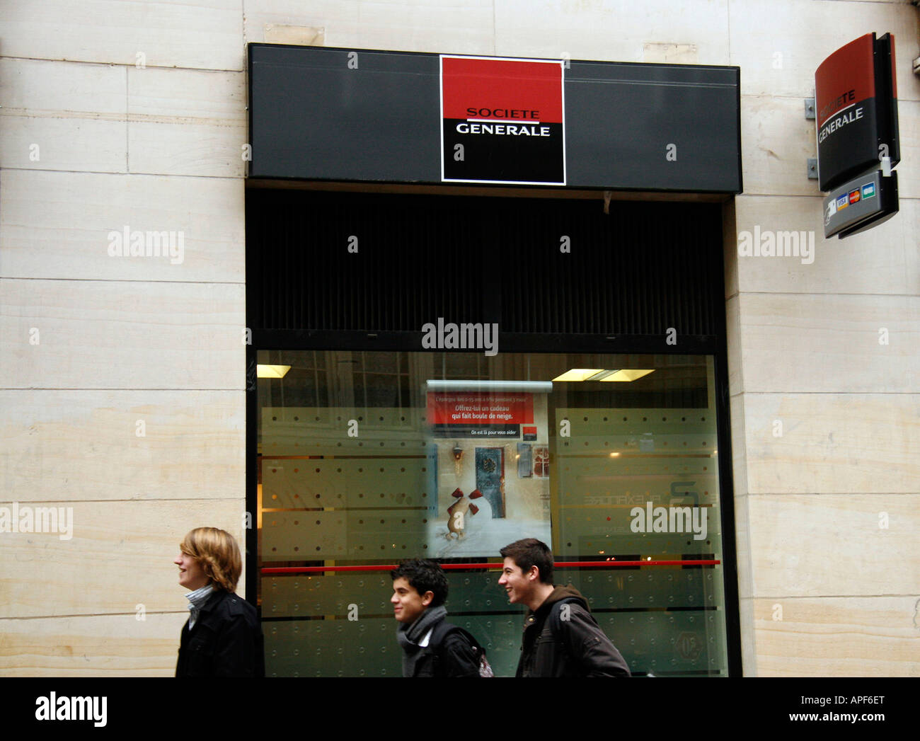 Youths walk past a Societe Generale bank in Rouen Seine Maritime France Stock Photo